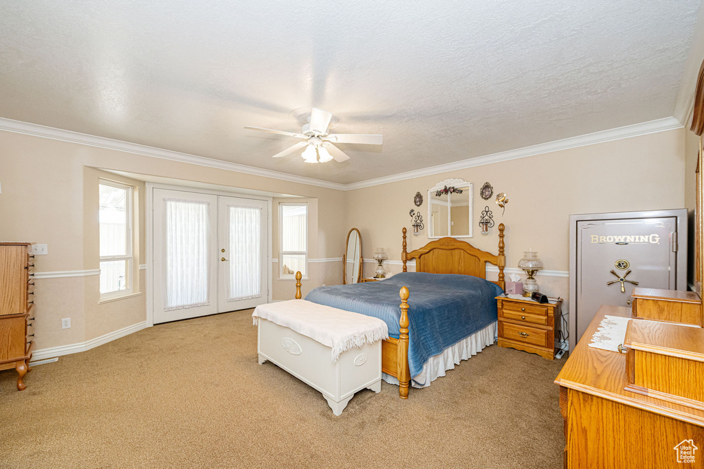 Bedroom featuring ornamental molding, french doors, light carpet, and access to exterior