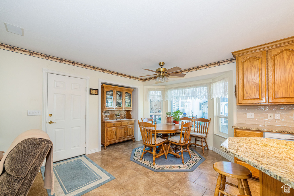 Dining room with baseboards and a ceiling fan