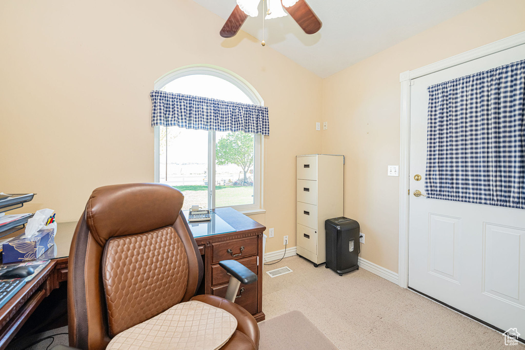 Office with a ceiling fan, visible vents, light colored carpet, baseboards, and lofted ceiling