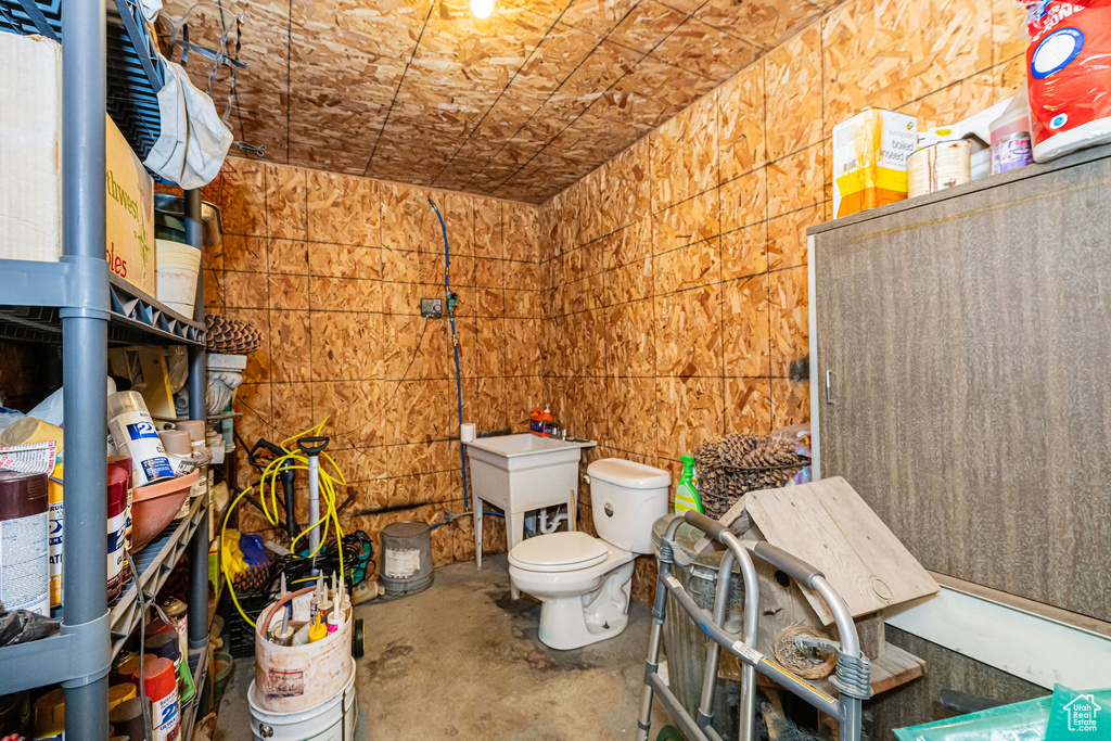 Bathroom featuring toilet and concrete flooring