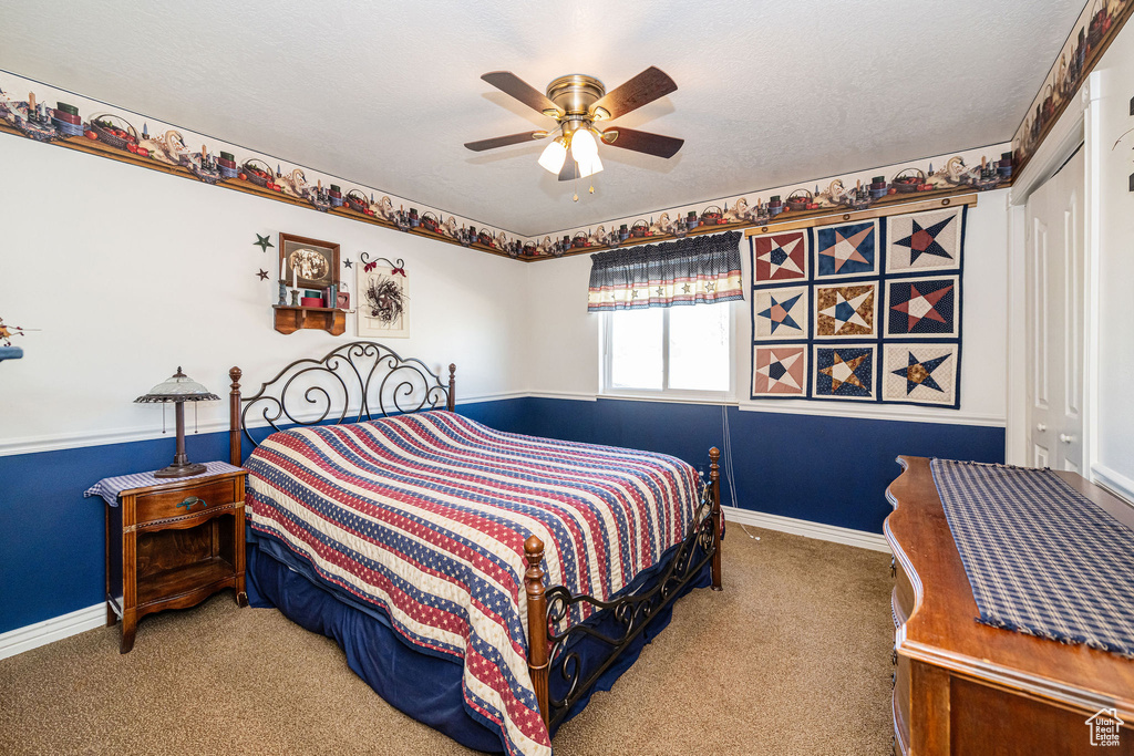 Bedroom with carpet floors, baseboards, and ceiling fan
