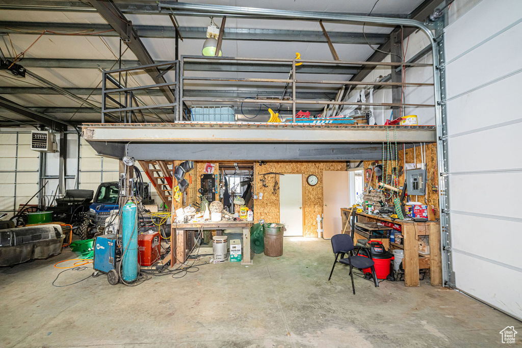 Garage with a workshop area and electric panel