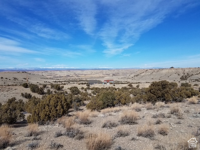 Mountain view with view of desert and a rural view
