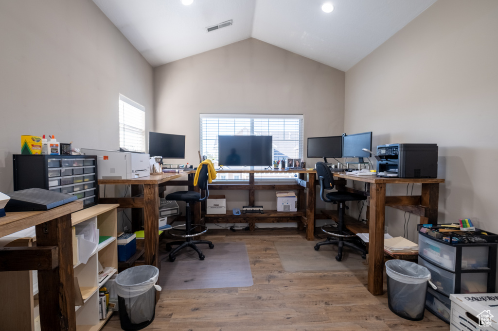 Office featuring wood finished floors and vaulted ceiling