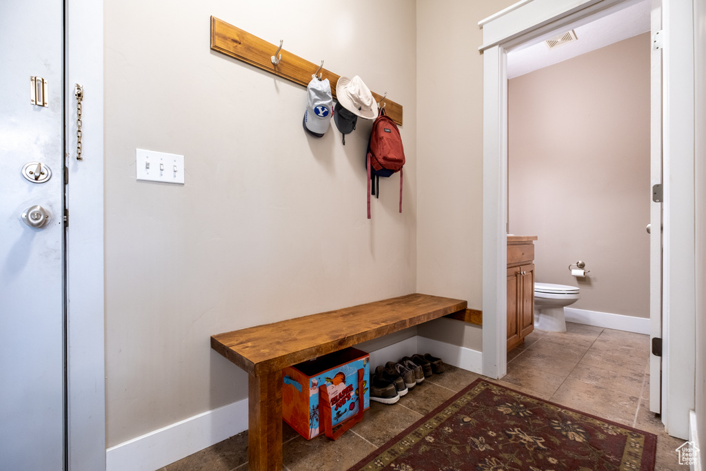 Mudroom with baseboards and tile patterned floors