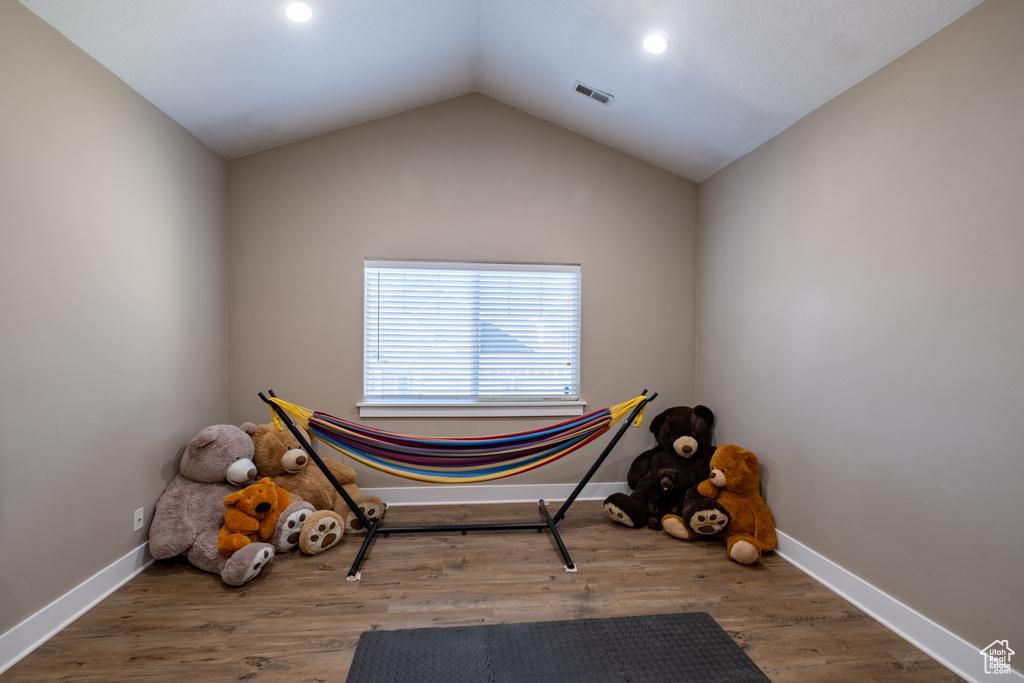 Misc room featuring lofted ceiling, recessed lighting, wood finished floors, and baseboards