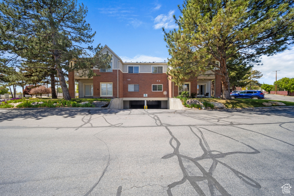 View of front of house featuring brick siding and a garage