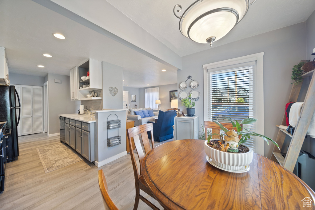 Dining area featuring baseboards, recessed lighting, and light wood-style flooring