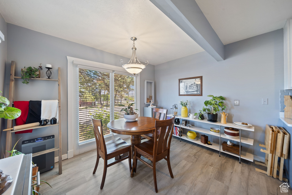 Dining space with light wood-type flooring, heating unit, and radiator