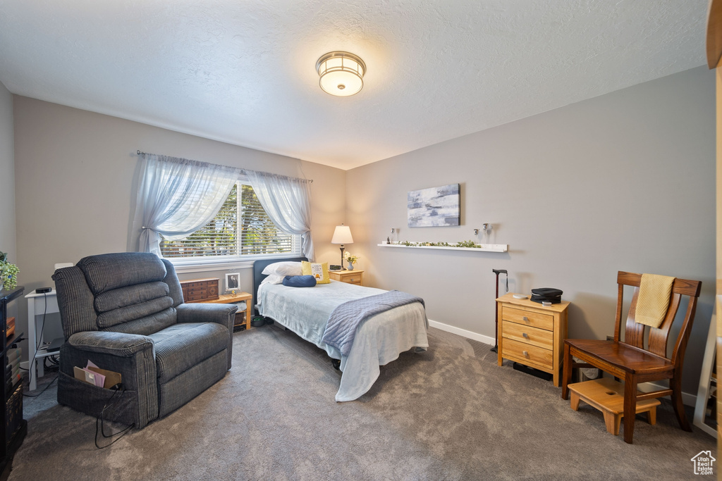 Carpeted bedroom featuring baseboards