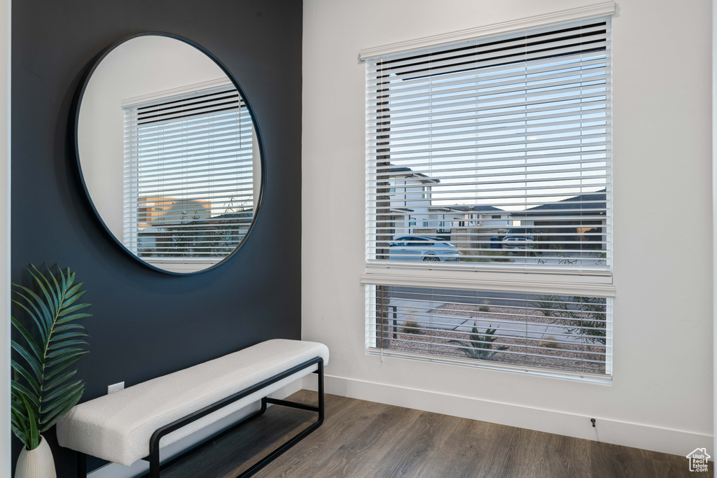 Interior space featuring a healthy amount of sunlight, baseboards, and wood finished floors