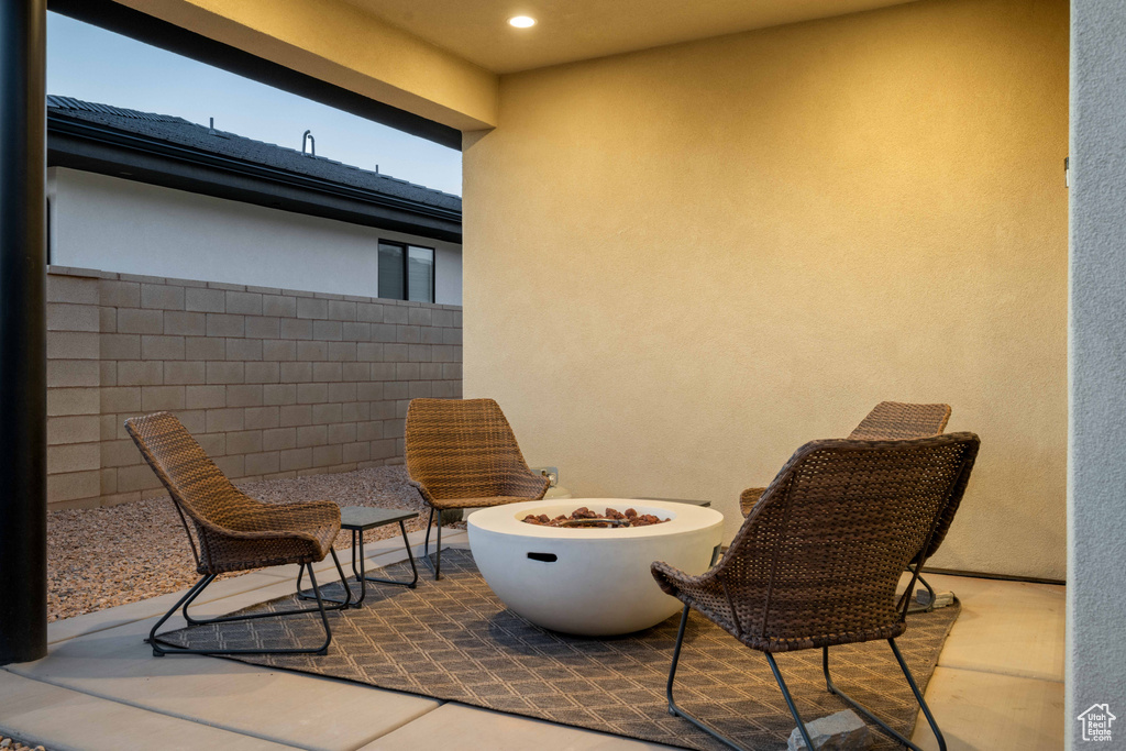 Balcony with a fire pit and a patio area