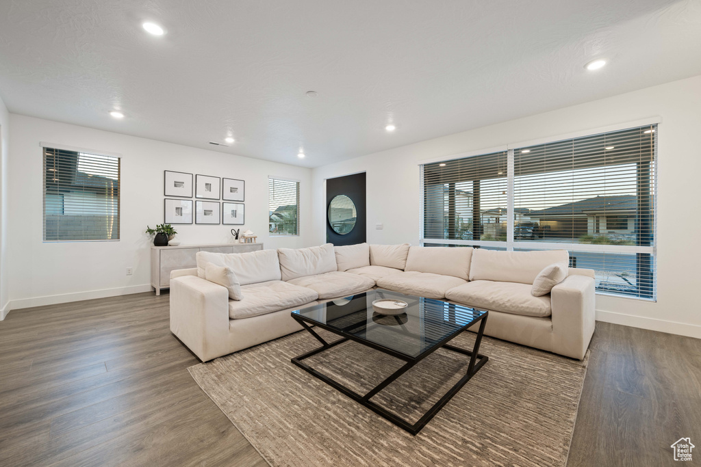 Living area featuring recessed lighting, baseboards, and wood finished floors