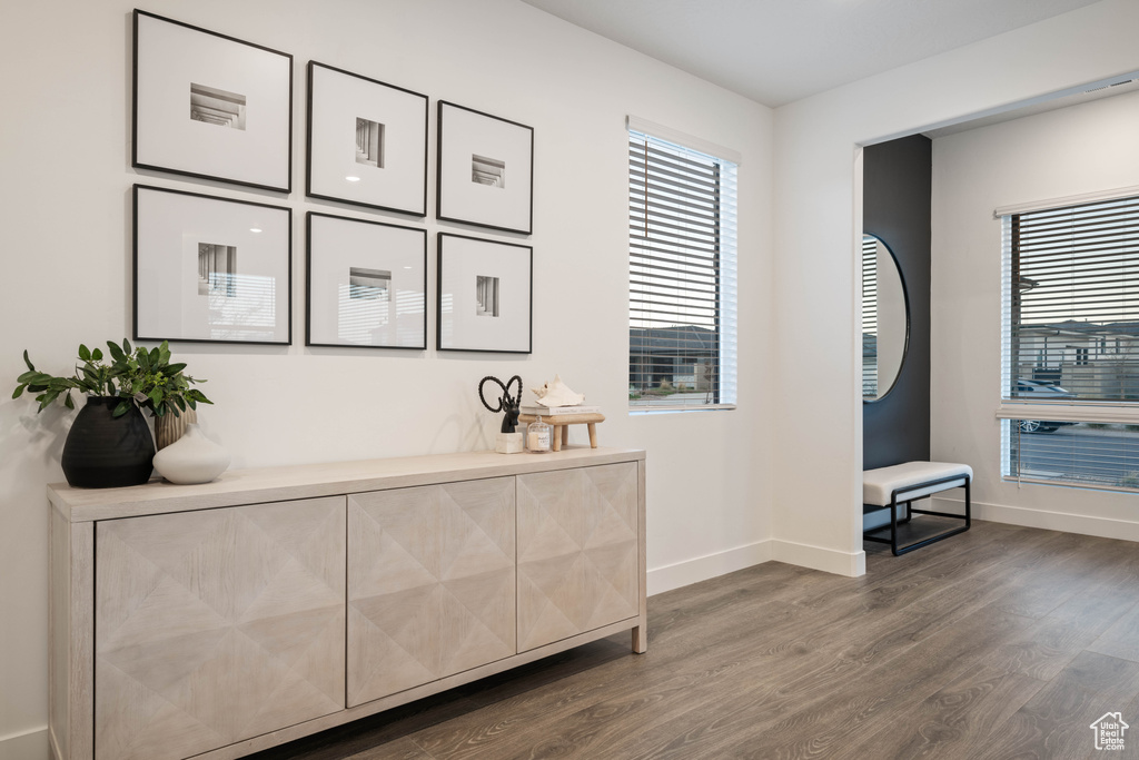 Interior space featuring baseboards, plenty of natural light, and wood finished floors