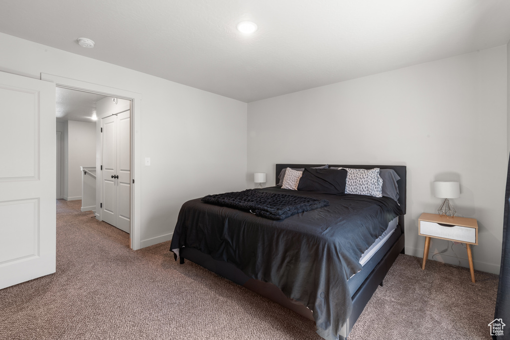 Carpeted bedroom with baseboards