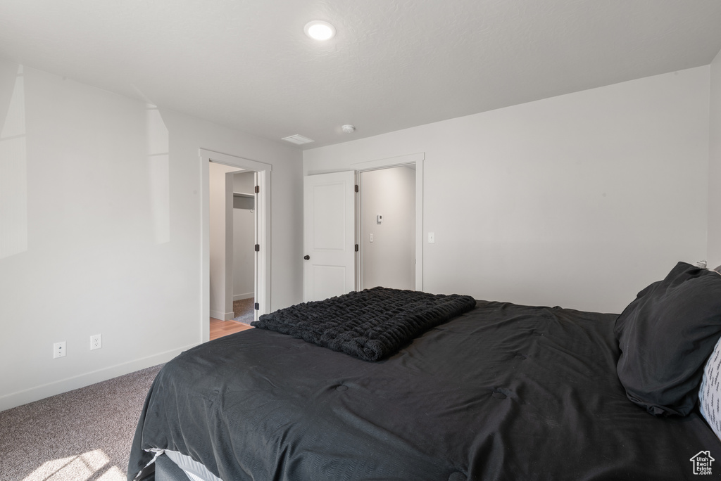 Bedroom featuring baseboards and carpet