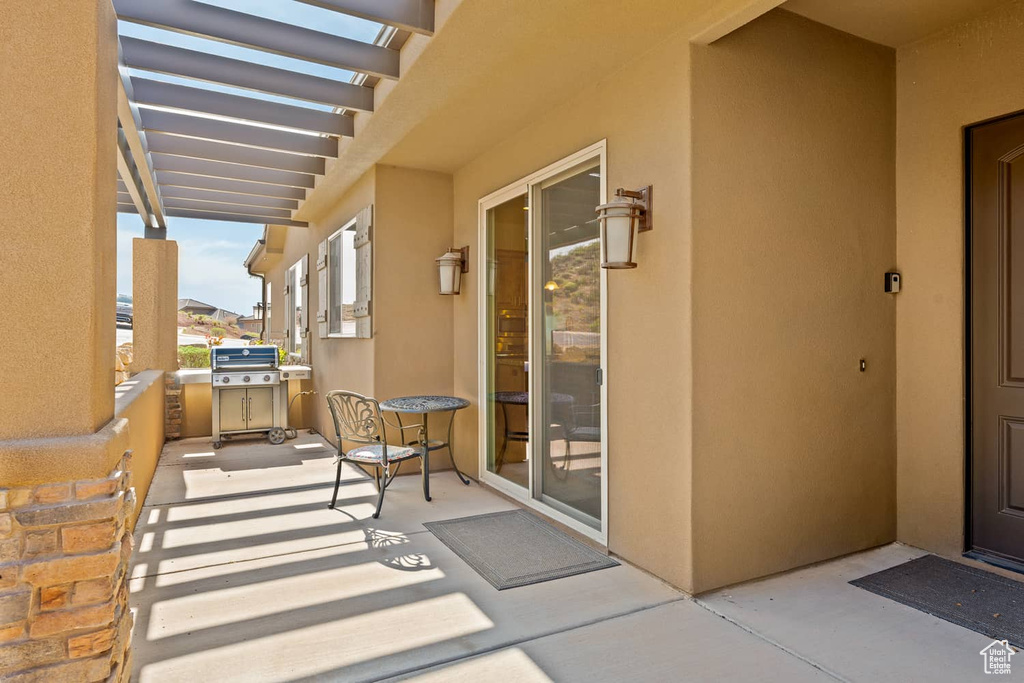 Exterior space featuring a pergola and stucco siding