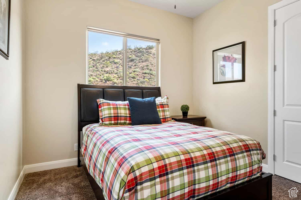 Bedroom featuring baseboards and carpet flooring