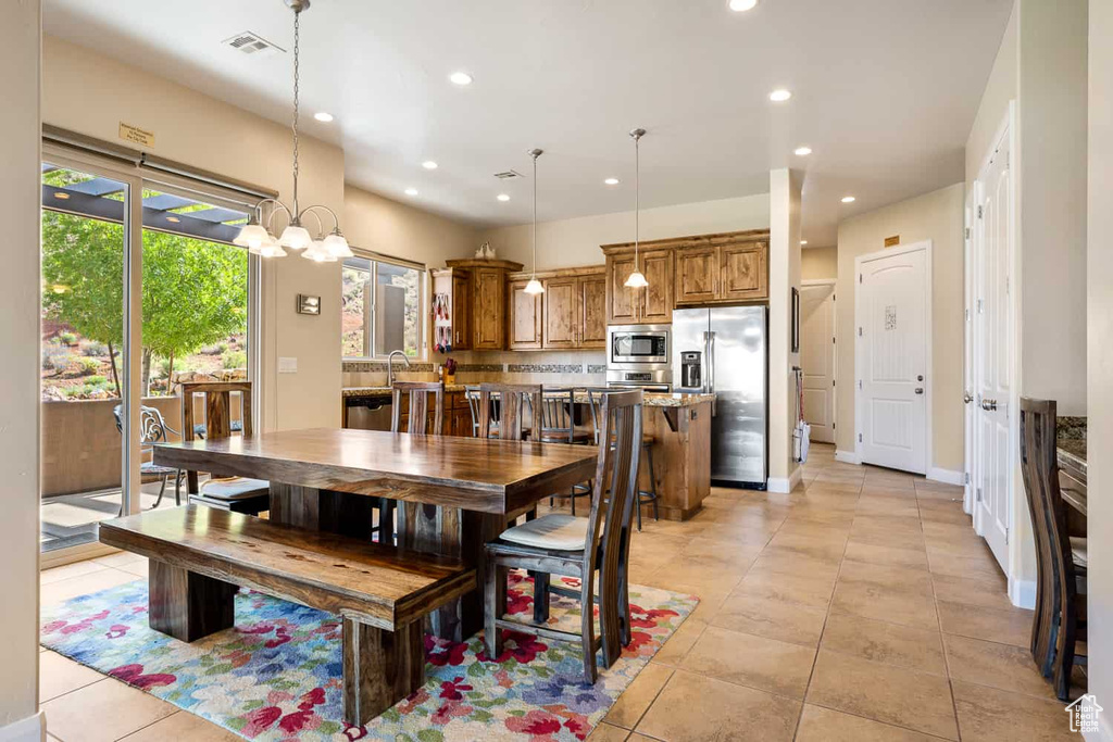 Dining area with light tile patterned floors, recessed lighting, and visible vents