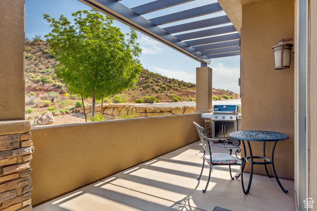 Balcony with a pergola and a grill