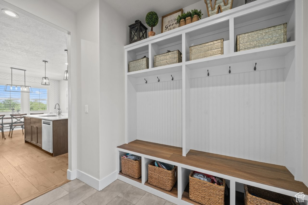 Mudroom featuring a sink and baseboards