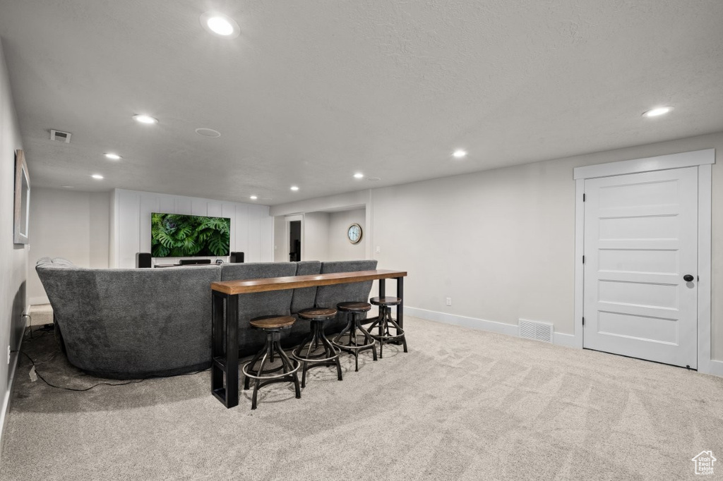 Bar with carpet flooring, recessed lighting, visible vents, and bar area
