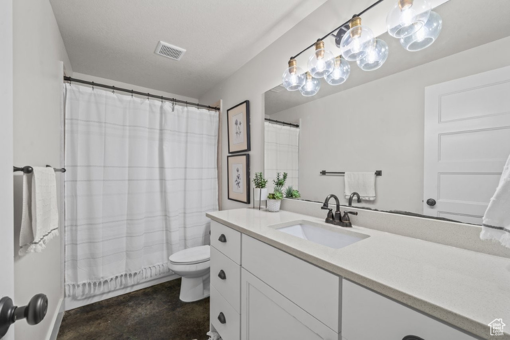 Full bathroom featuring visible vents, finished concrete flooring, vanity, toilet, and a shower with shower curtain