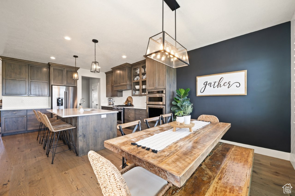 Dining area with light wood-style floors, baseboards, and recessed lighting