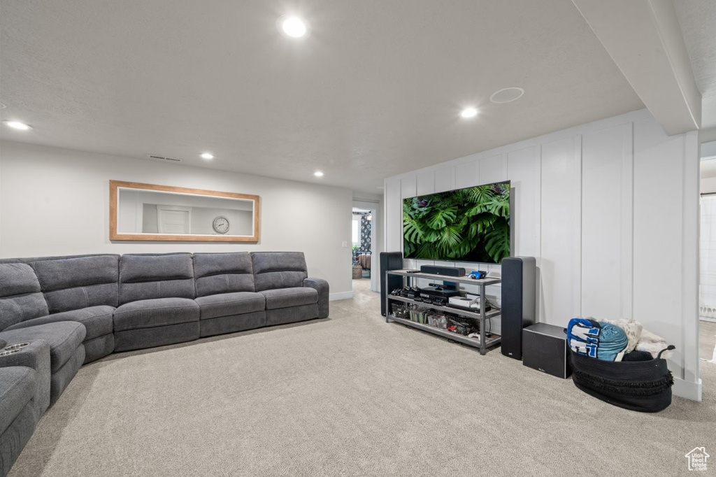 Living room with carpet floors, recessed lighting, and visible vents