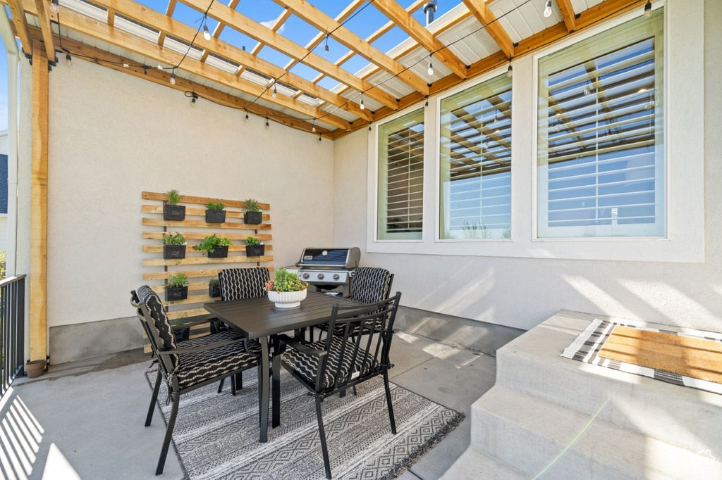 View of patio / terrace with outdoor dining area, a pergola, and area for grilling