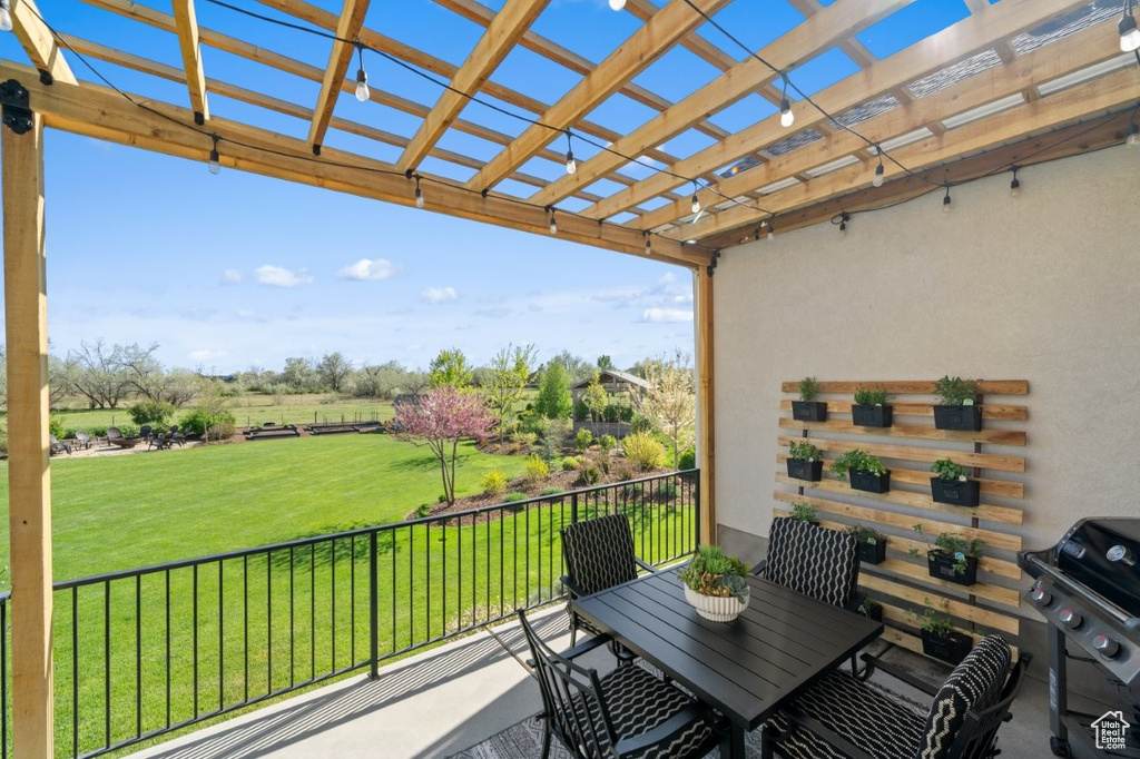 Balcony with grilling area, a pergola, and outdoor dining area