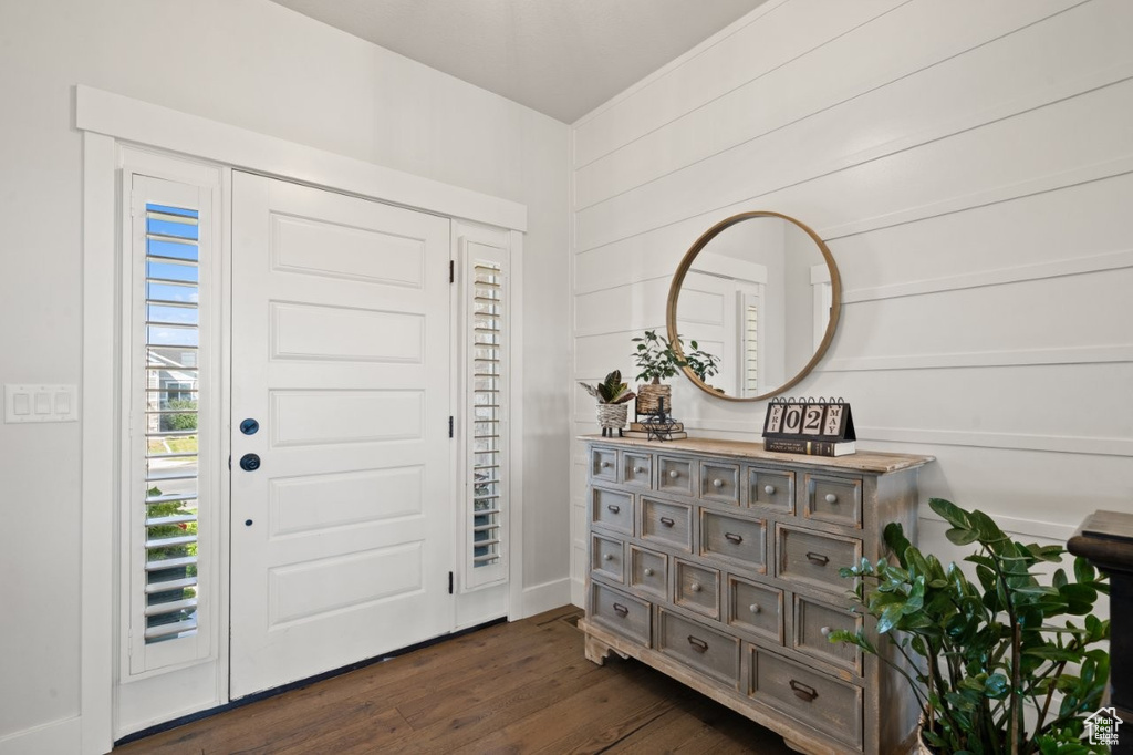 Foyer featuring baseboards and dark wood-style floors