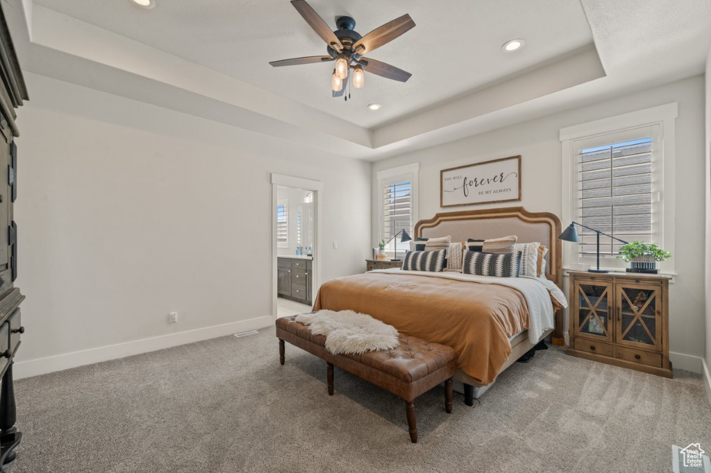 Bedroom featuring a raised ceiling, baseboards, recessed lighting, and visible vents
