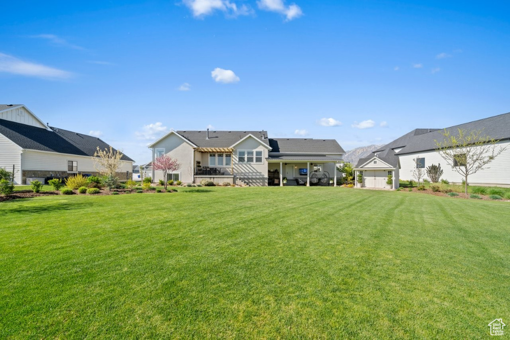 Back of house featuring a yard