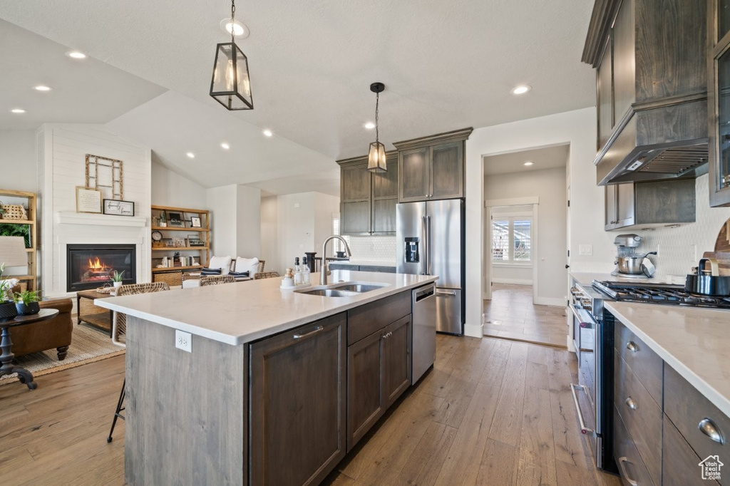 Kitchen featuring light countertops, a sink, hardwood / wood-style floors, and stainless steel appliances
