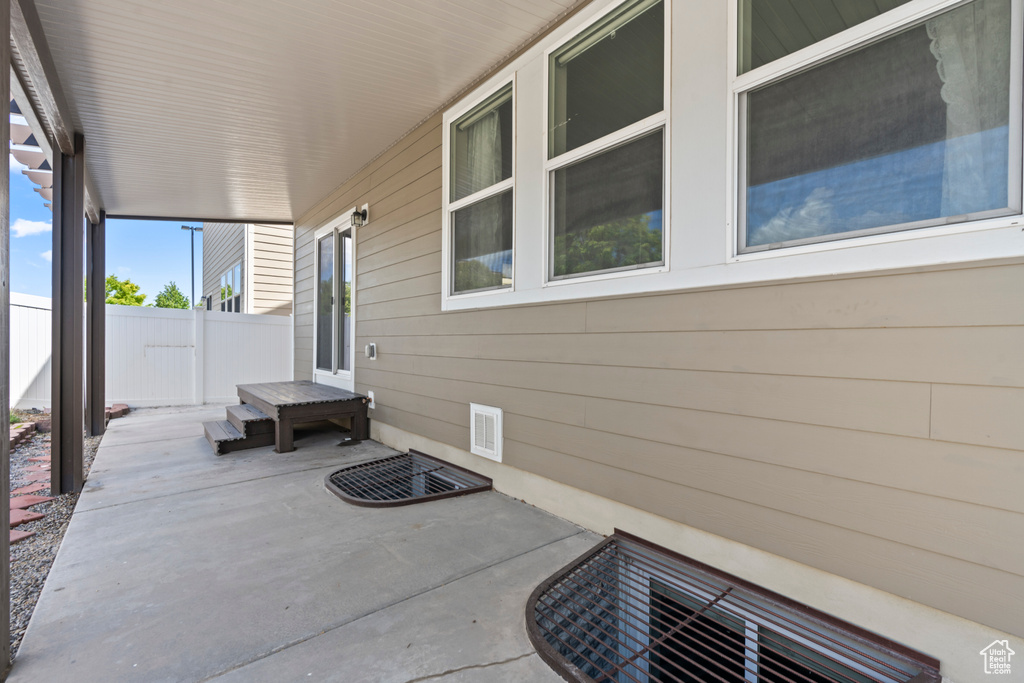 View of patio featuring fence