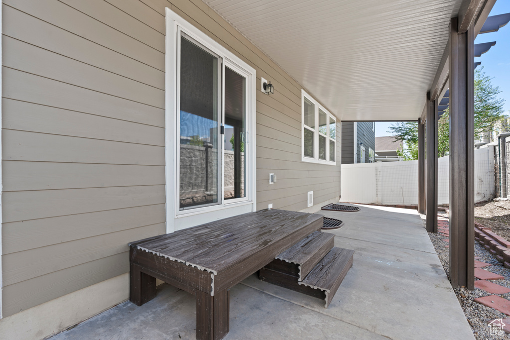 View of patio with fence