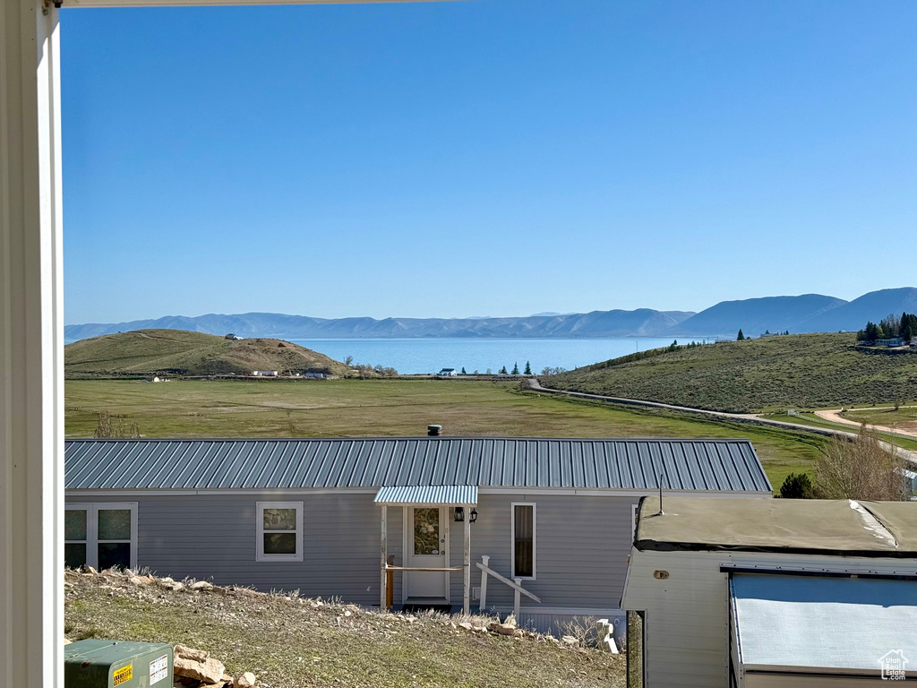 View of front of home with a water and mountain view