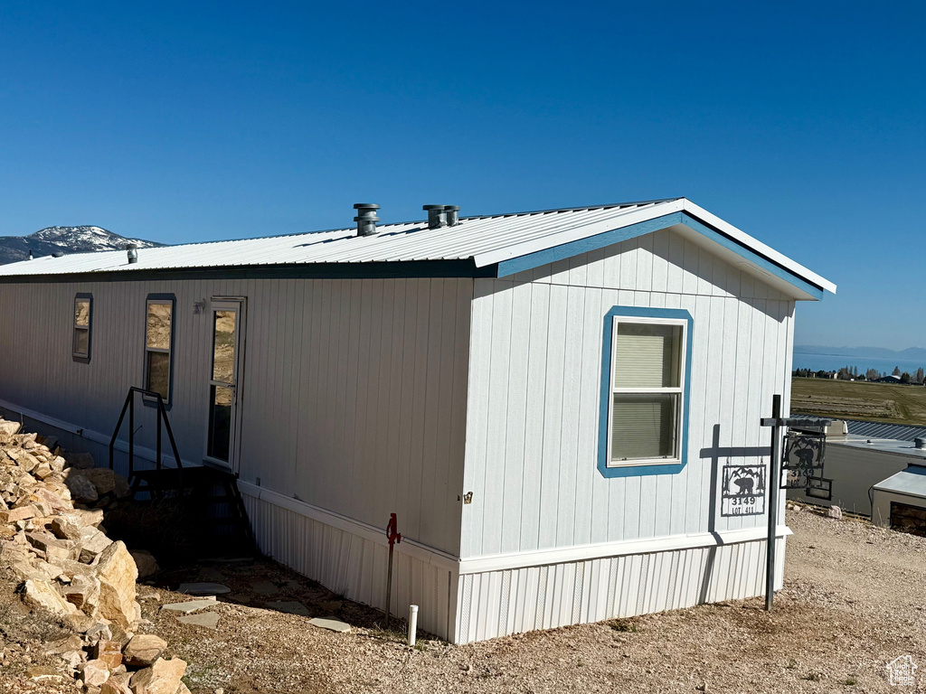 View of home's exterior with a mountain view and metal roof