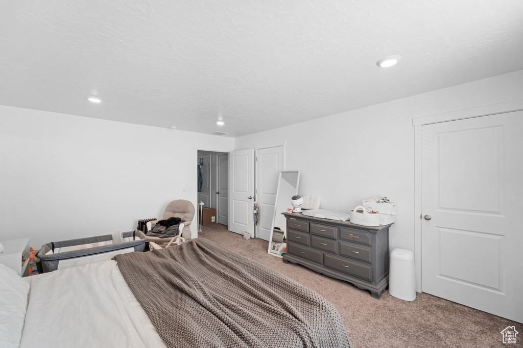 Bedroom with recessed lighting and light carpet