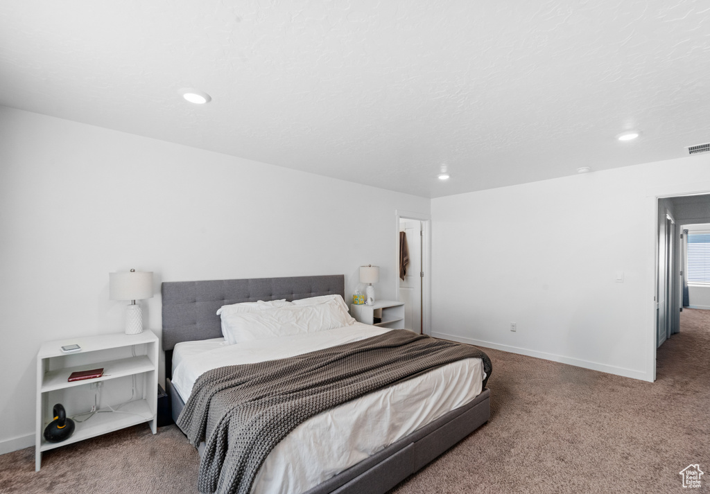 Carpeted bedroom featuring recessed lighting, baseboards, and visible vents