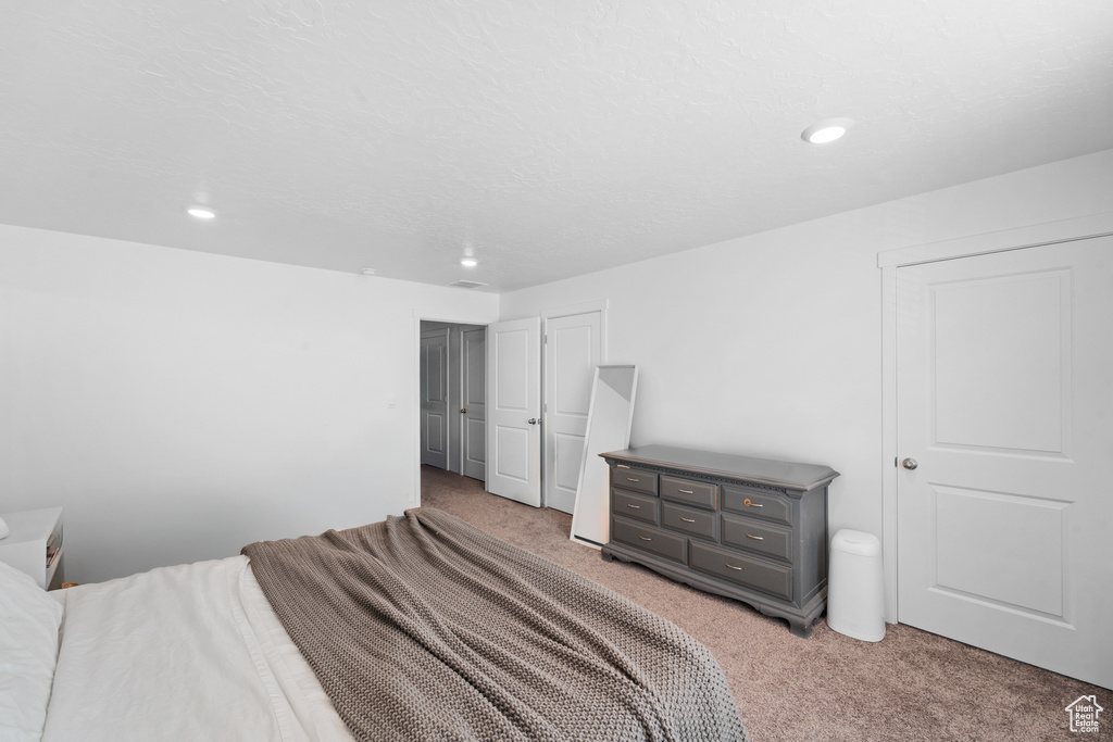 Bedroom featuring light carpet and recessed lighting