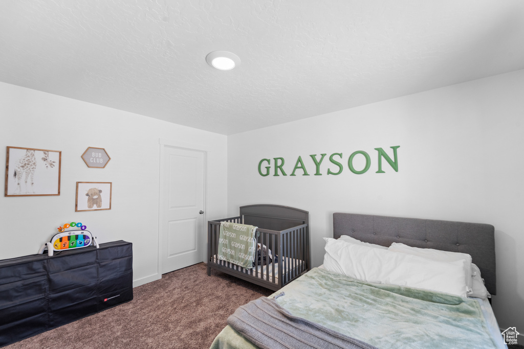 Carpeted bedroom featuring baseboards