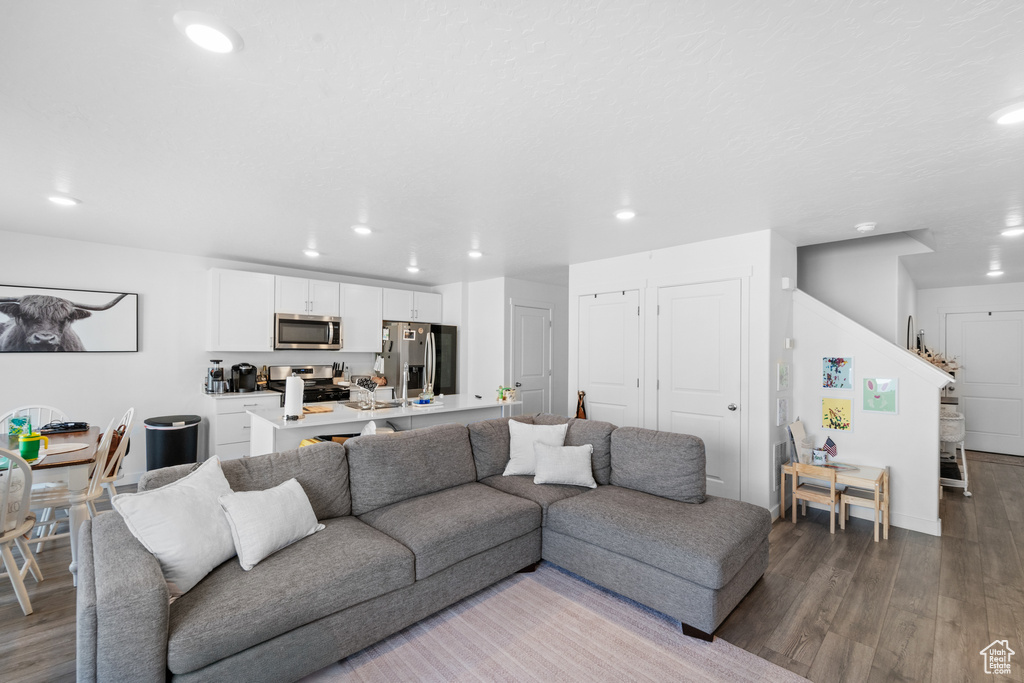 Living area featuring stairway, recessed lighting, and wood finished floors