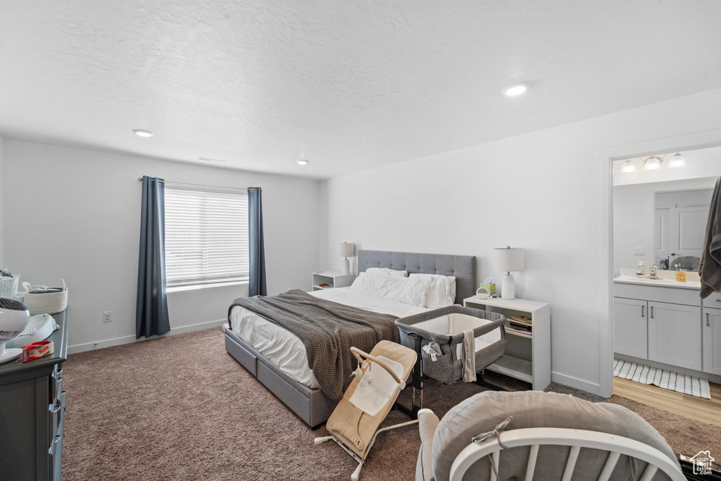 Bedroom featuring baseboards, recessed lighting, and ensuite bath