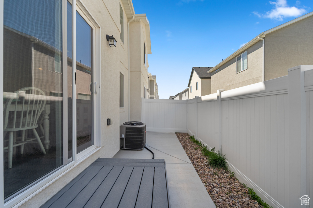View of patio featuring central air condition unit and a fenced backyard