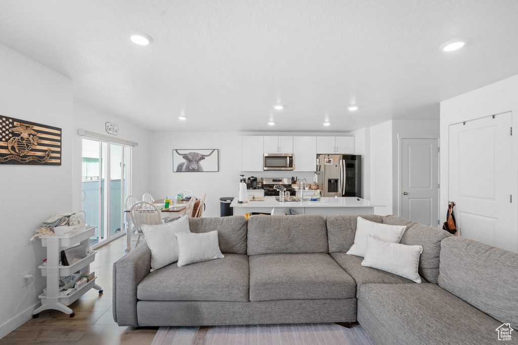 Living area featuring recessed lighting, baseboards, and wood finished floors