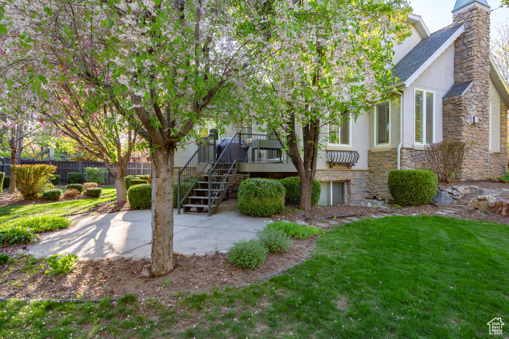 Exterior space featuring stairway, a patio, and fence