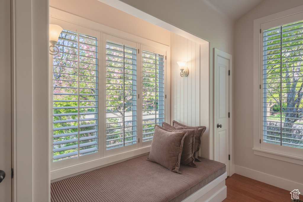 Living area with baseboards and wood finished floors