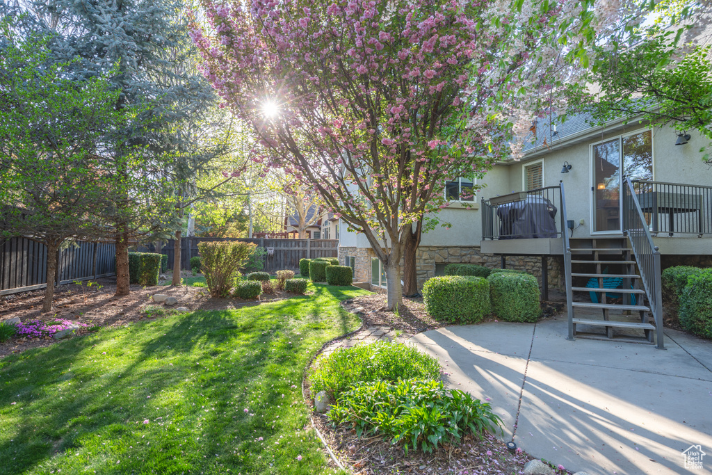 View of yard with stairway, fence, and a wooden deck